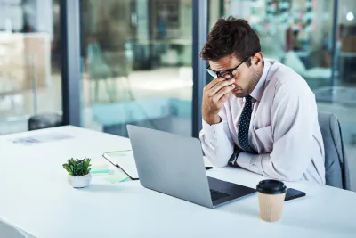 Picture of a man working on with a laptop