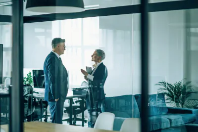 Picture of a man and a woman talking in office